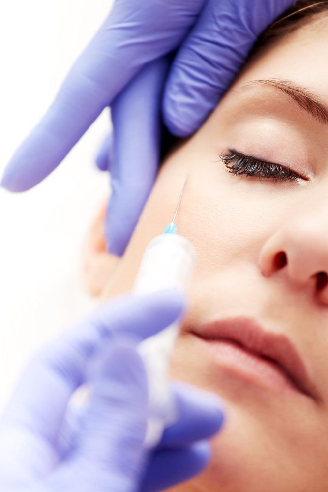 Woman getting injectables to the face