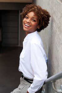 a woman standing on a staircase while smiling